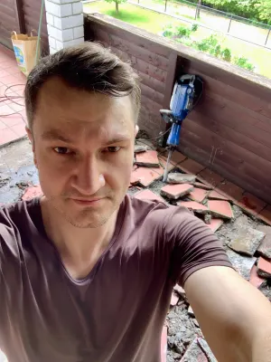 Markus Oberlehner doing work on a balcony to prepare it for a renovation.